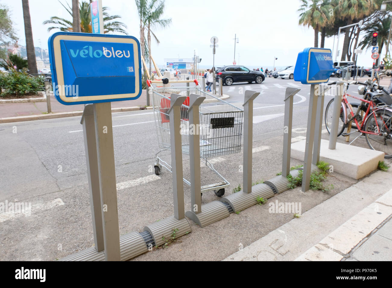 Nice, France. Empty shopping trolley parked at Velo Bleu bicycle station Stock Photo