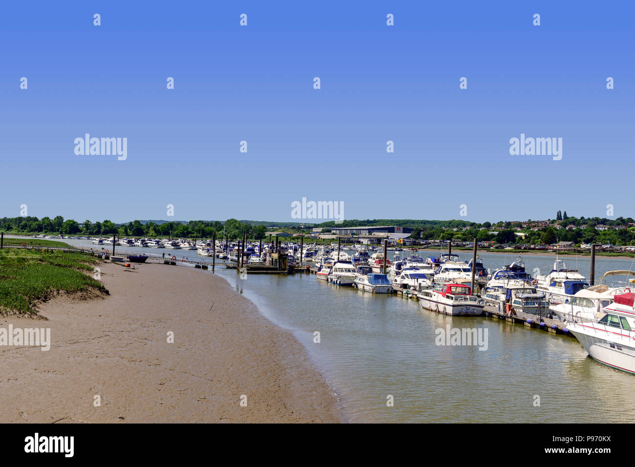 moored boats along side mudflats on the river medway Stock Photo Alamy