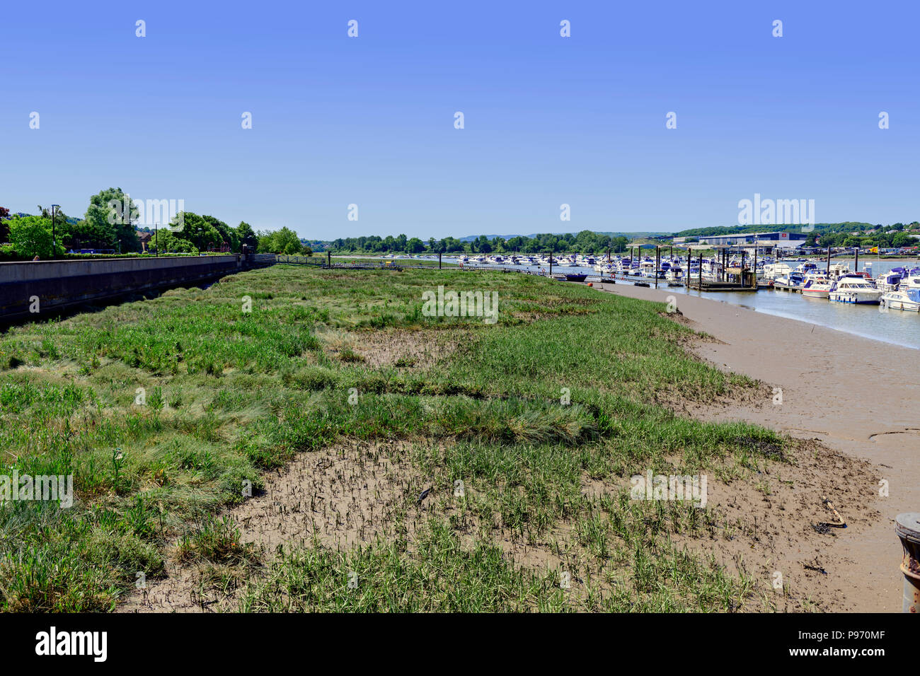 moored boats along side mudflats on the river medway Stock Photo