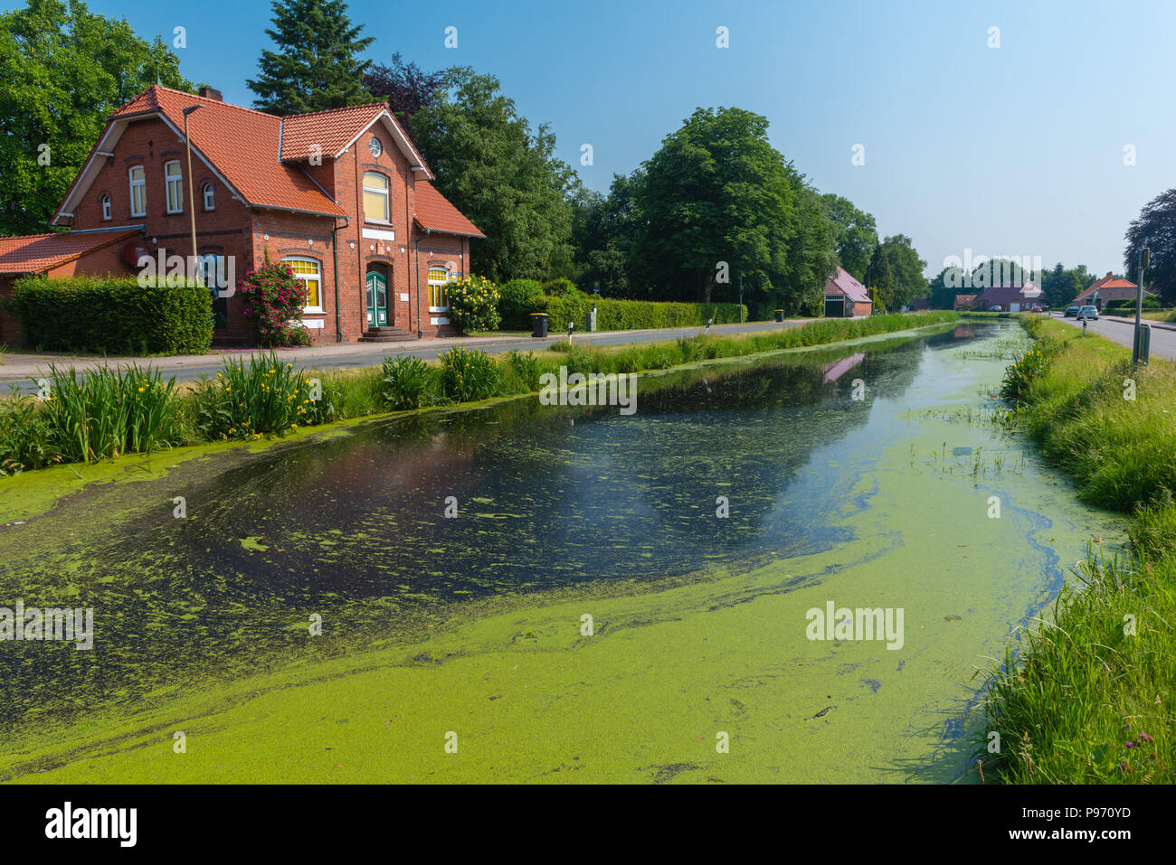 Fehnkanal,houses along a canal, formerly for transportation of peat, Grossefehn, East Frisia, Lower Saxony, Germany, Europe Stock Photo