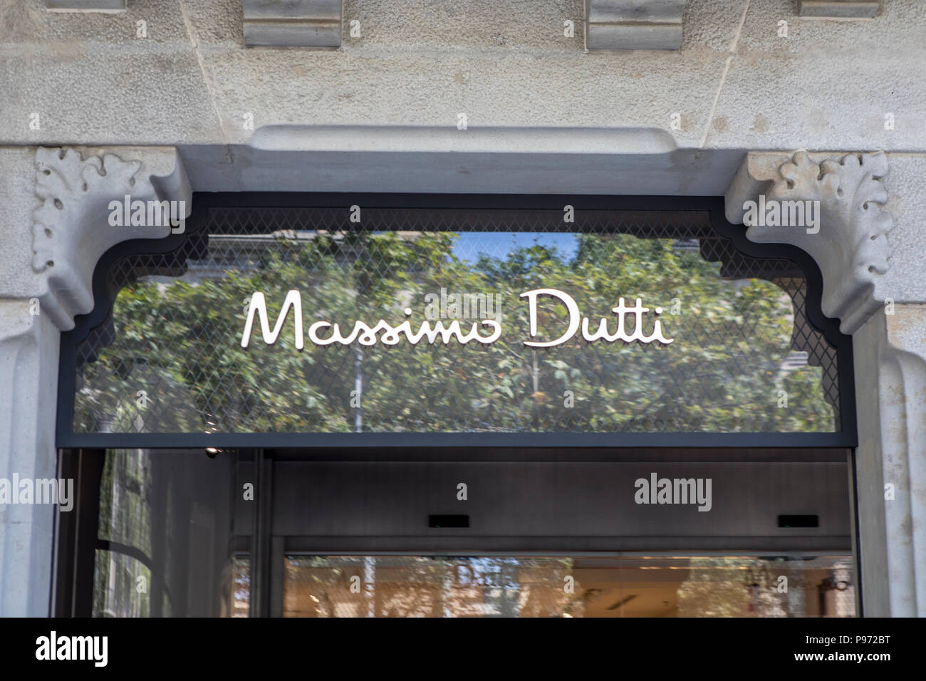 Massimo Dutti sign on Passeig de Gràcia street in Barcelona. Barcelona is a  city in Spain. It is the capital and largest city of Catalonia, as well as  the second most populous