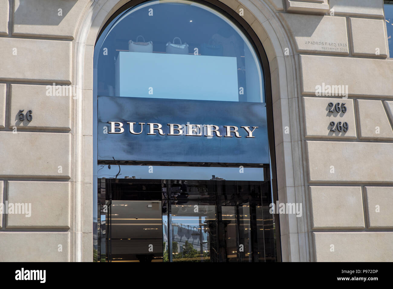 Burberry sign on Passeig de Gràcia street in Barcelona. Barcelona is a city  in Spain. It is the capital and largest city of Catalonia, as well as the  second most populous municipality