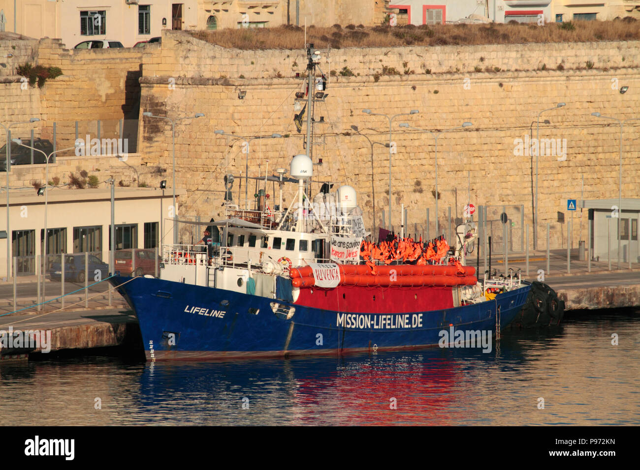 The rescue ship Lifeline, operated by the German NGO Mission Lifeline, in Malta. A poster on the side says 'Free Iuventa' - see explanation below. Stock Photo