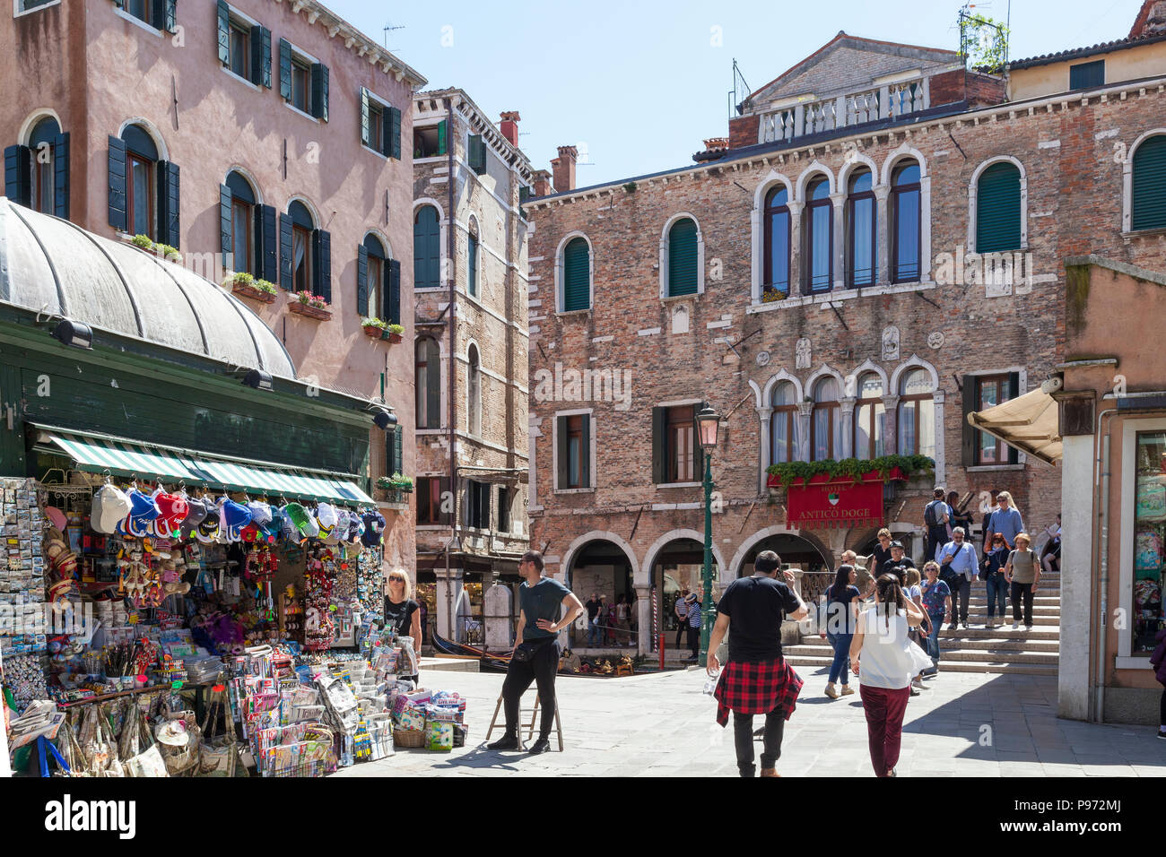 Campo Santi Apostoli and the Antico Doge Hotel, Cannaregio, Venice, Veneto, Italy with a news agent selling souvenirs and tourists Stock Photo