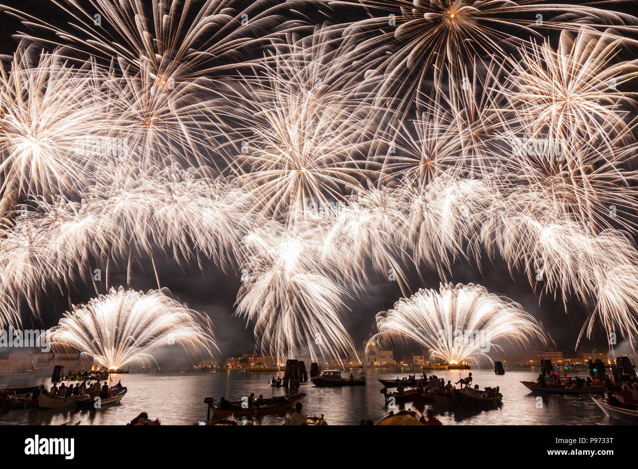Fireworks, pyrotechnics, display at Festa del Redentore, St Marks Basin and Giudecca Canal, Venice, Veneto, Italy  dedicated to Christ the Redeemer. Stock Photo