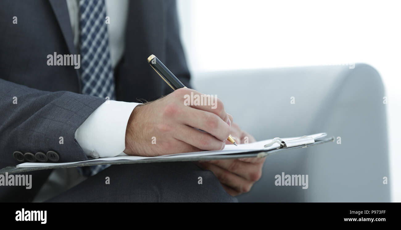 Businessman signs a contract. Holding pen in hand Stock Photo - Alamy