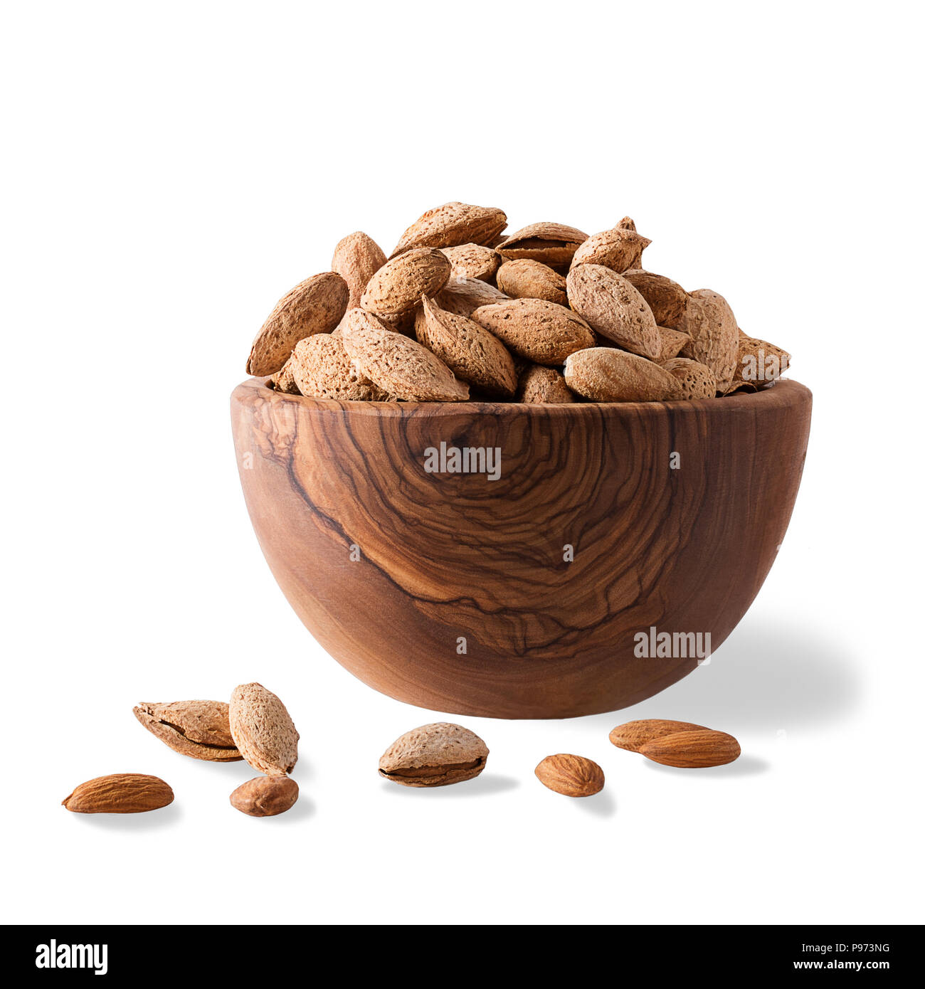 Bowl of almonds on white. Almond nuts with shell ina wood bowl Isolated on white background. Stock Photo