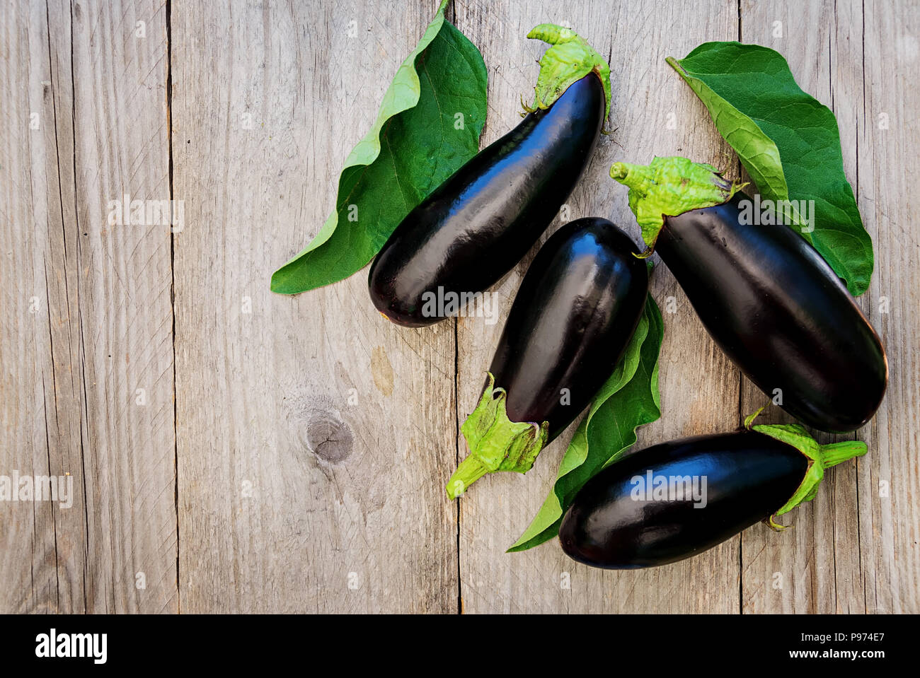 Ripe eggplants on a wooden background. Top view, flat lay. Stock Photo