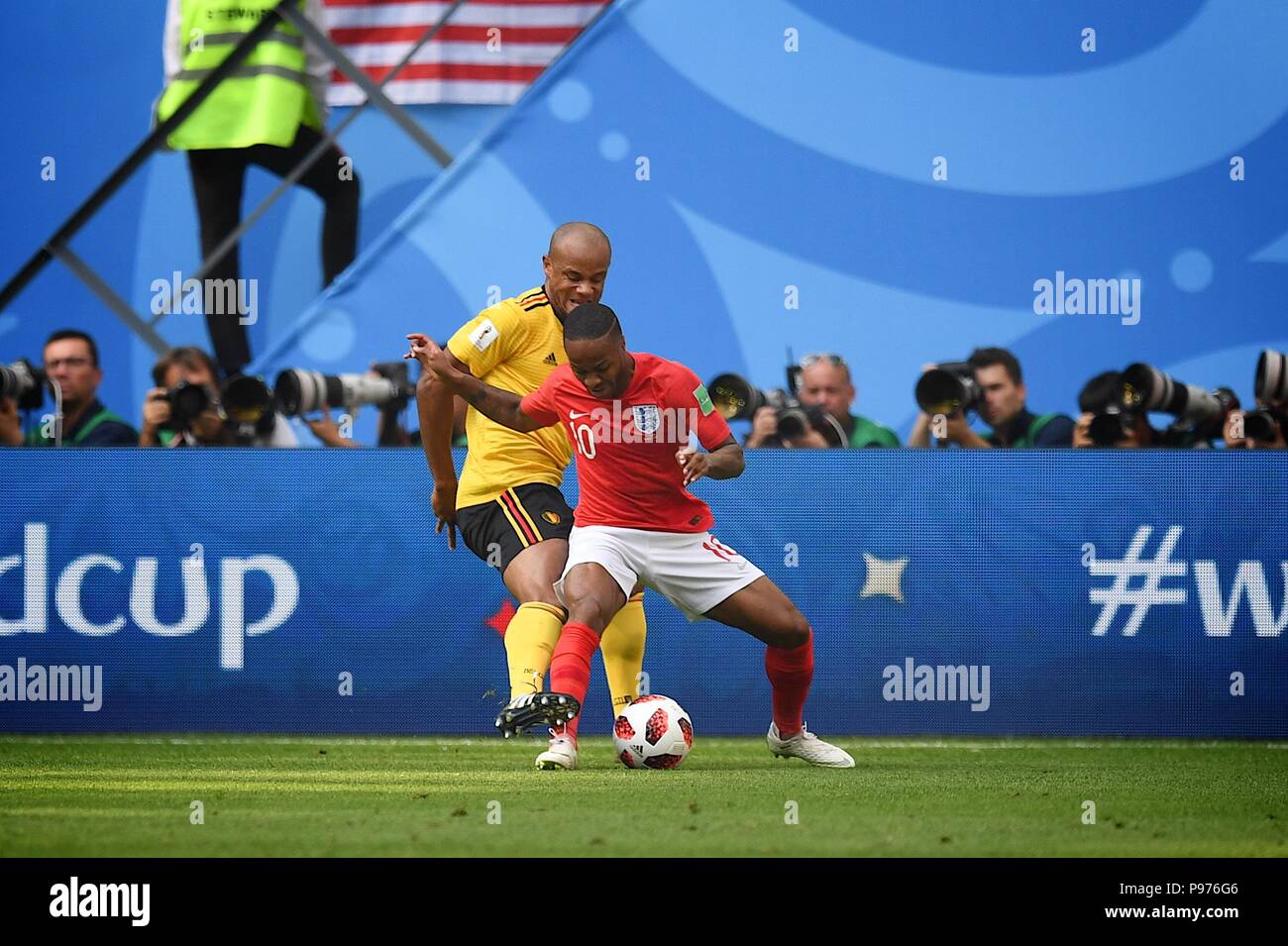 July 14th, 2018, St, Petersburg, Russia. Raheem Sterling(10) of England and  Vincent Company of Belgium compete for the ball during the 2018 FIFA World Cup Russia match between England and Belgium at Saint-Petersburg Stadium, Russia. Shoja Lak/Alamy Live News Stock Photo