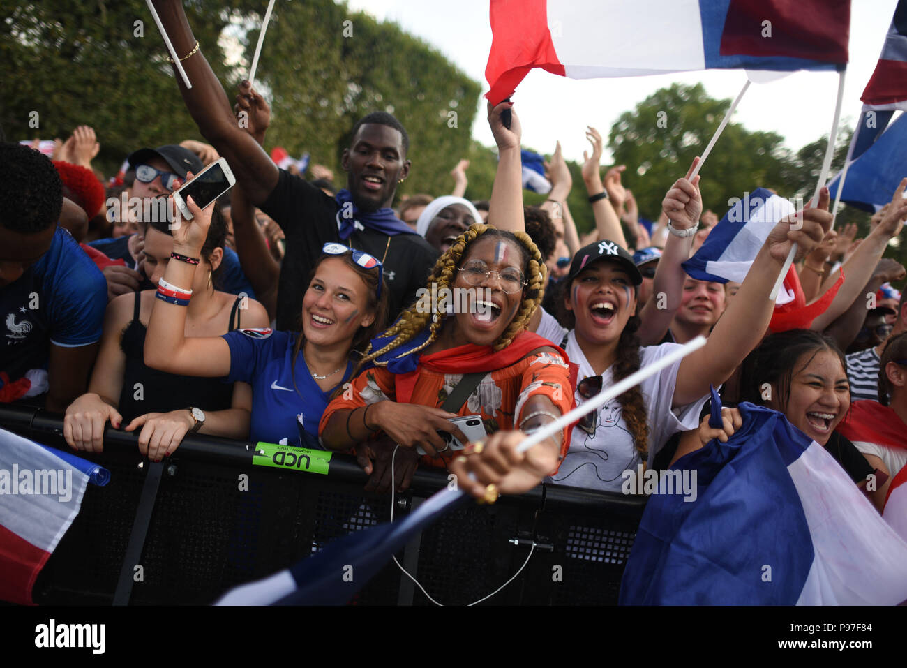 Paris, France. 15th July 2018. Supporters of the French football team at  the Champ-de-Mars fan zone celebrate as France win its World Cup Final  against Croatia 4-2. Des supporters de l'equipe de