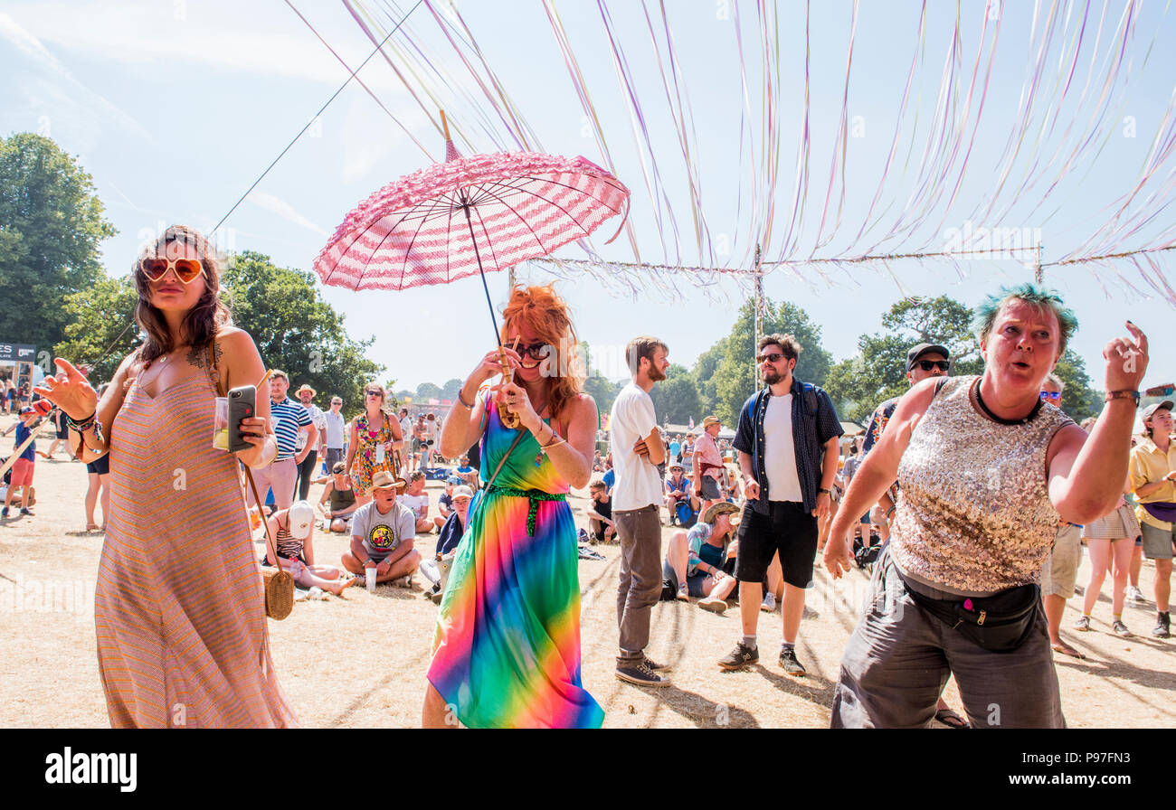 Three women dancing and enjoying themselves at Latitude Festival, Henham Park, Suffolk, England, 15th July, 2018 Stock Photo