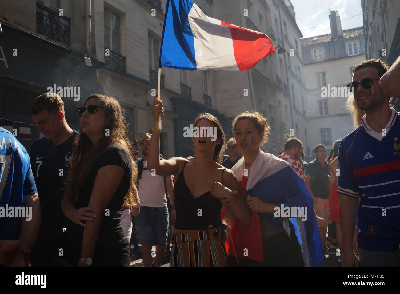 Women waving the French flag in Paris during 2018 football world cup final Stock Photo
