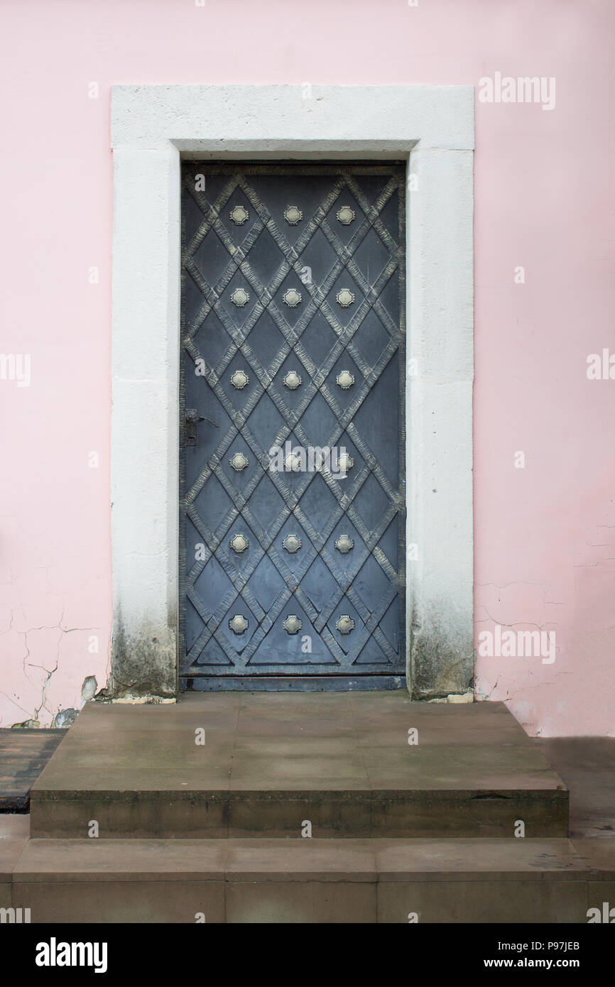 Photo of antique vintage old style forged decorated door. Stock Photo