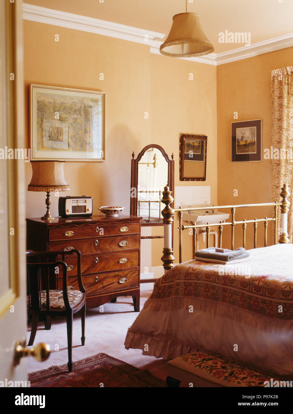 Antique Furniture In Peach Country Bedroom Stock Photo