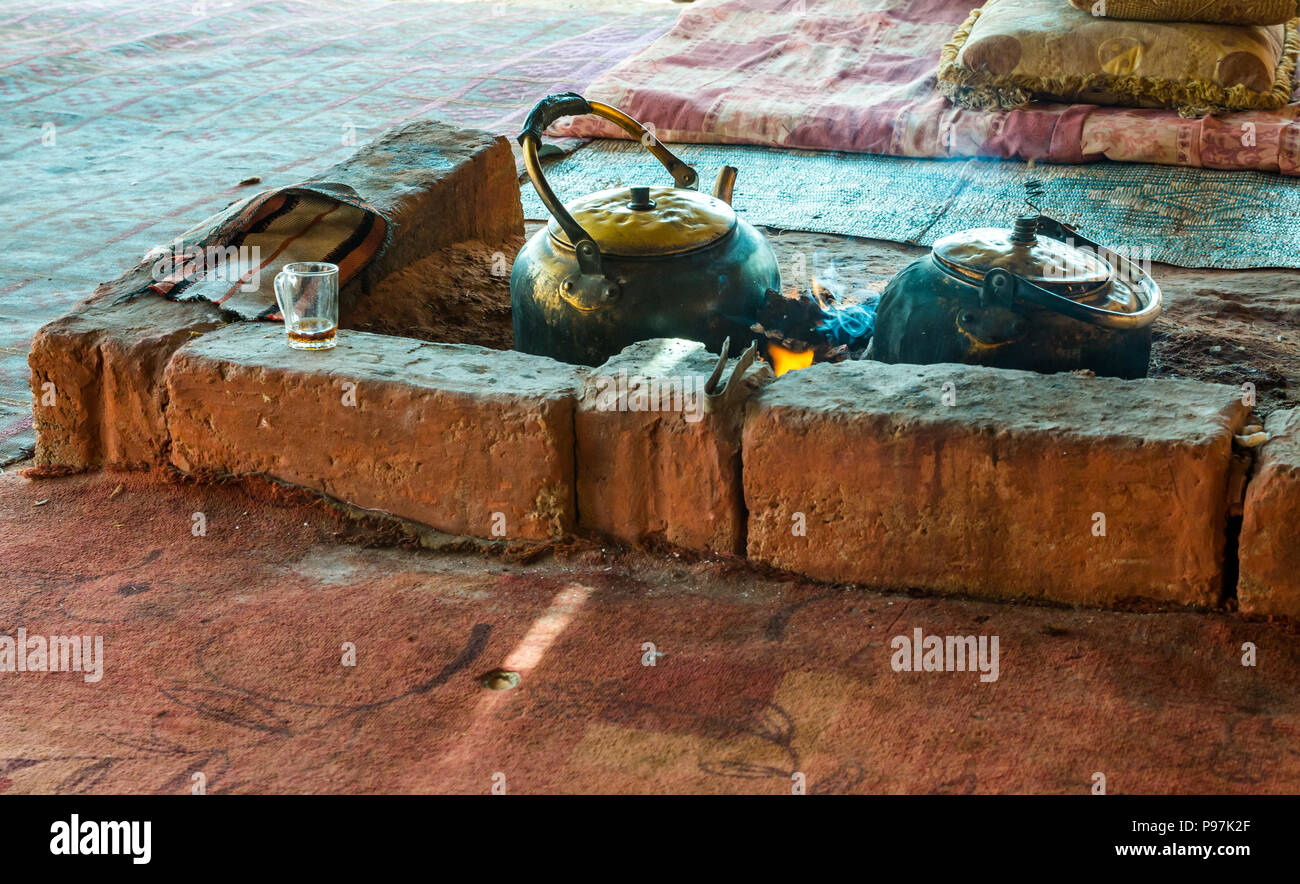 Large kettle pots on open fire brewing Bedouin tea, Bedouin camp, Wadi Rum desert valley, Jordan, Middle East Stock Photo