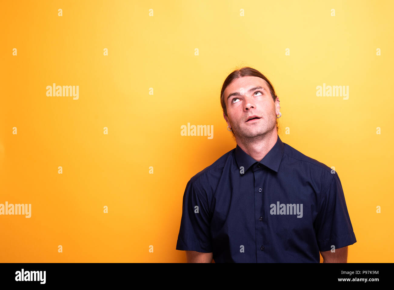 Expressive man looking up contemplative Stock Photo