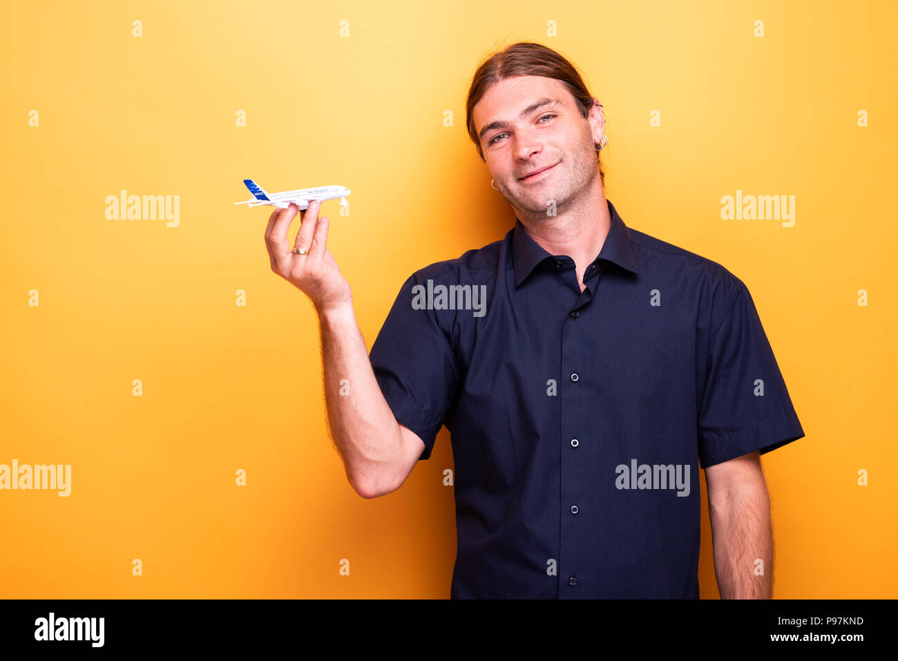 Man presenting toy airplane Stock Photo