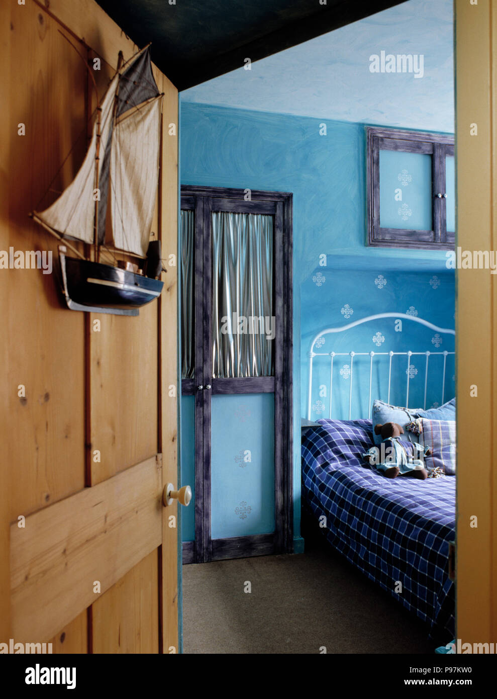 Open Pine Door To Child S Blue Bedroom With White Iron Bed