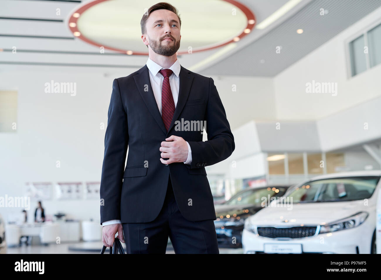 Businessman at auto salon Stock Photo