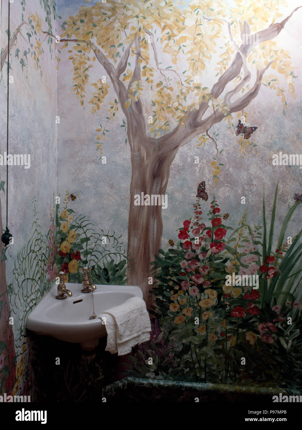 Mural of garden painted on the wall of an eighties bathroom Stock Photo
