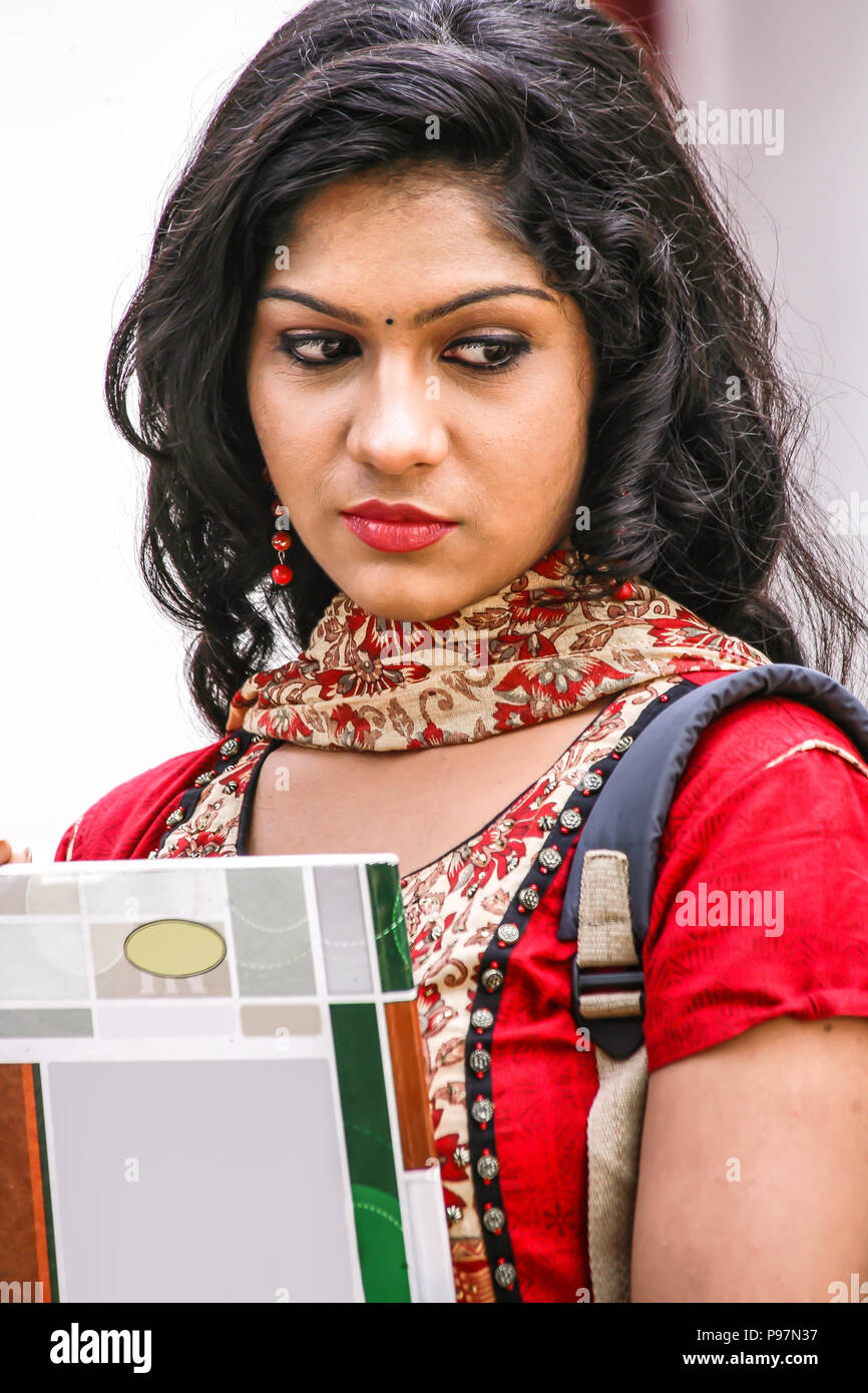 beautiful female student carrying books Stock Photo - Alamy