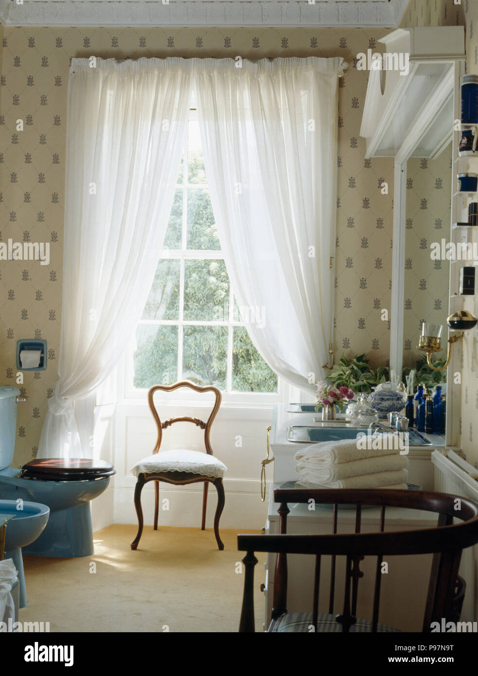 White voile curtains on window in traditional bathroom Stock Photo