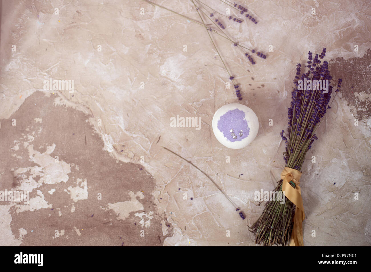 Natural cosmetics. Handmade lavender bath bombs, lavender flowers and towel on white wooden planks, top view Stock Photo