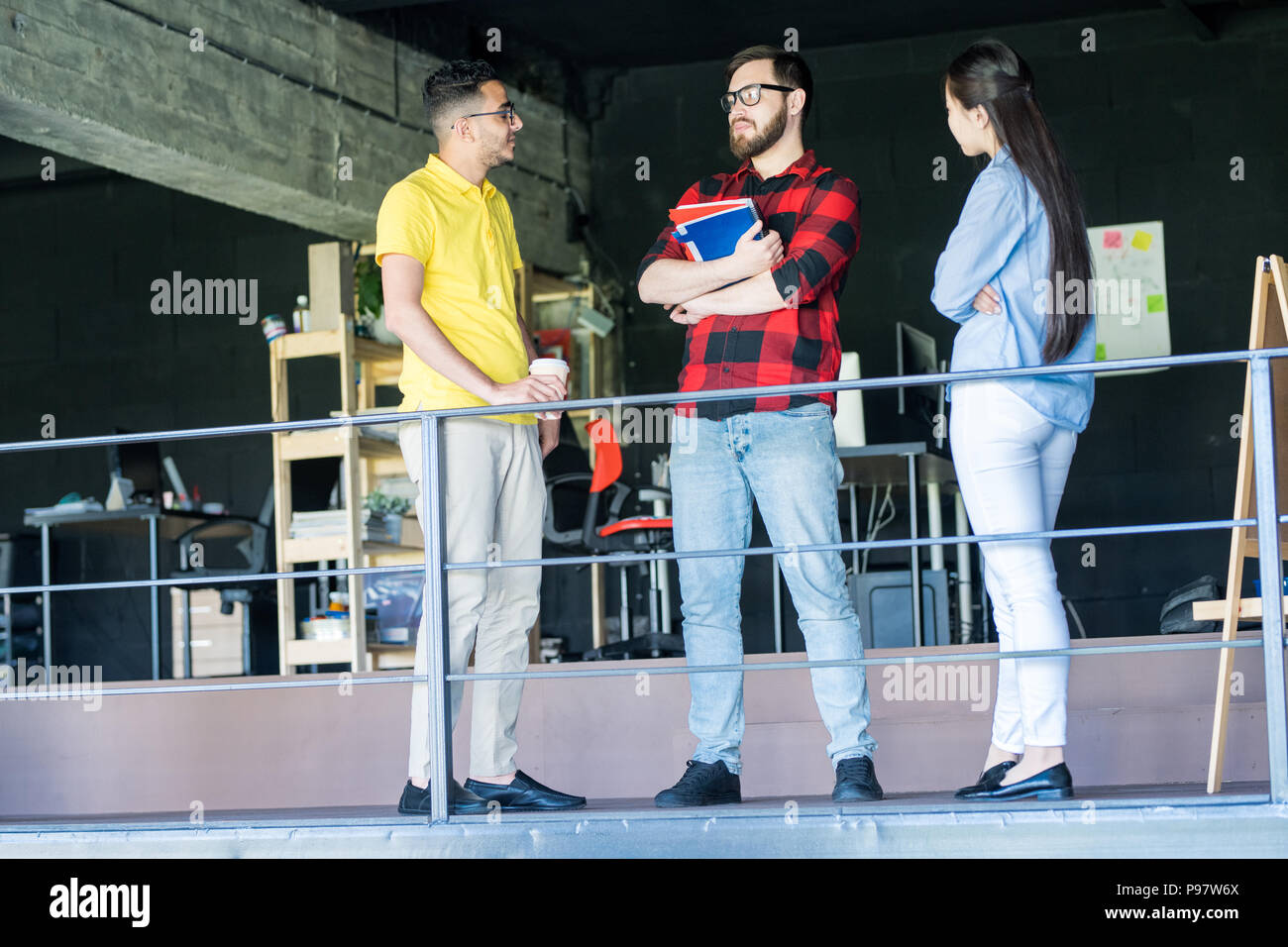 Team of Creative Young People Talking in Office Stock Photo