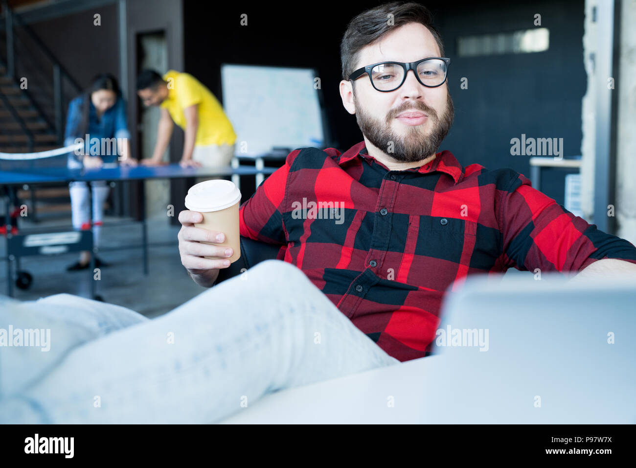 Modern Bearded Man Chilling in Office Stock Photo