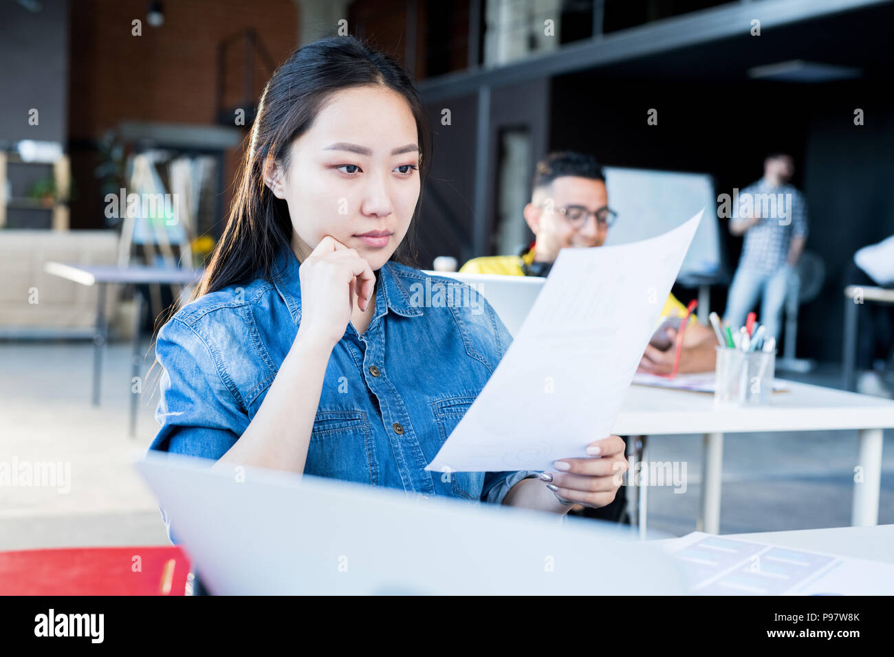 Young Asian Woman in Modern Office Stock Photo