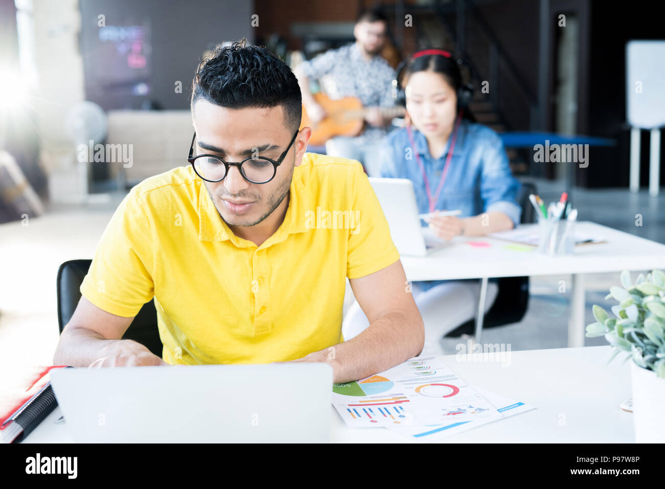 Young Middle Eastern Man Using Laptop in Office Stock Photo