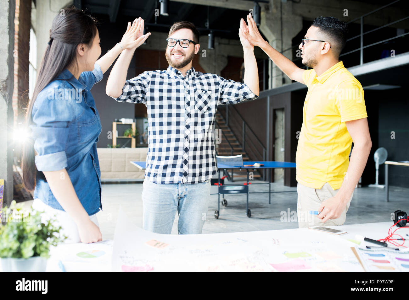 Creative Business Team High Five in Office Stock Photo