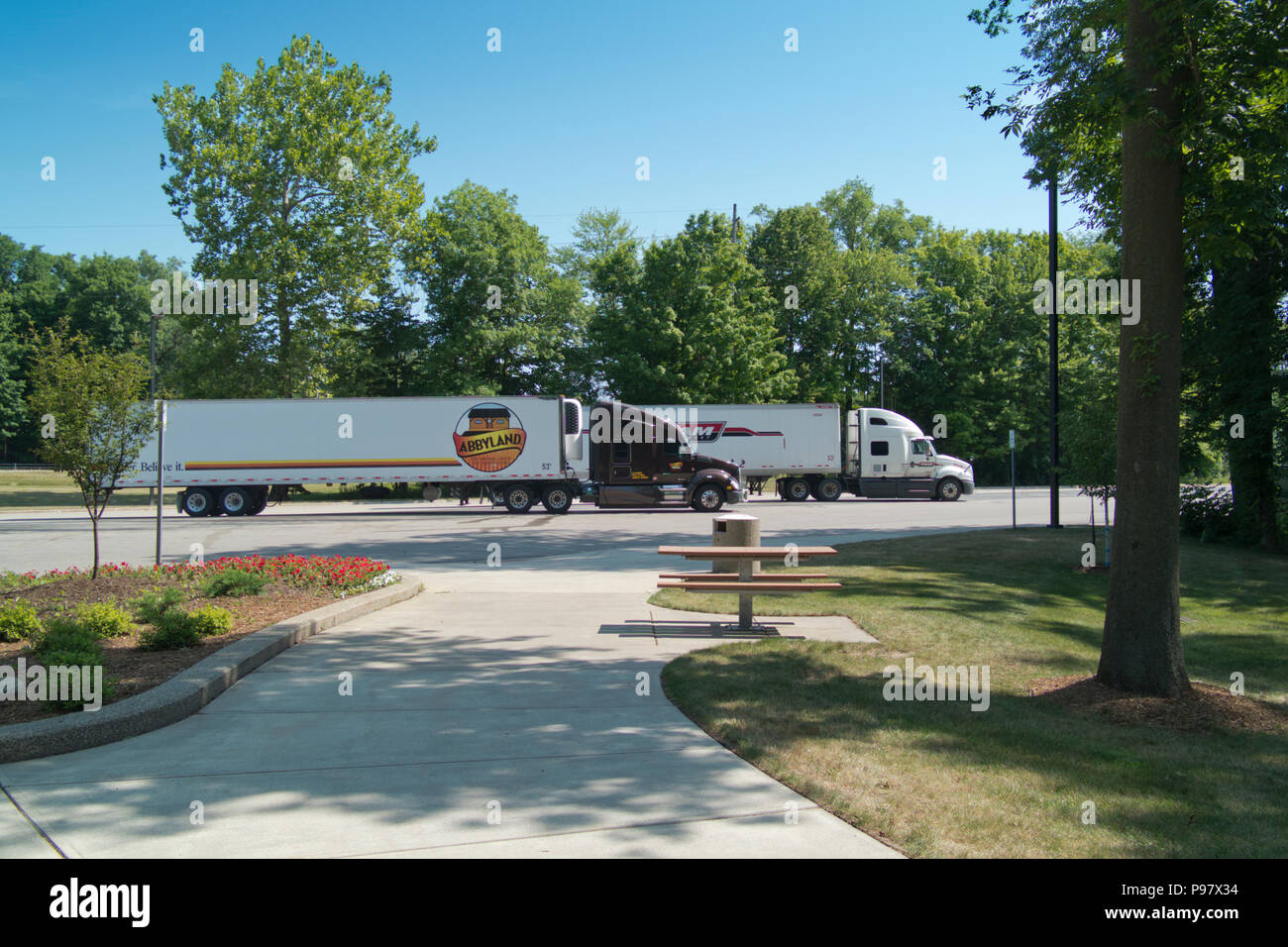 Two eighteen-wheelers angle parked at a rest area off I-96 near Grand Rapids, Michigan, USA Stock Photo