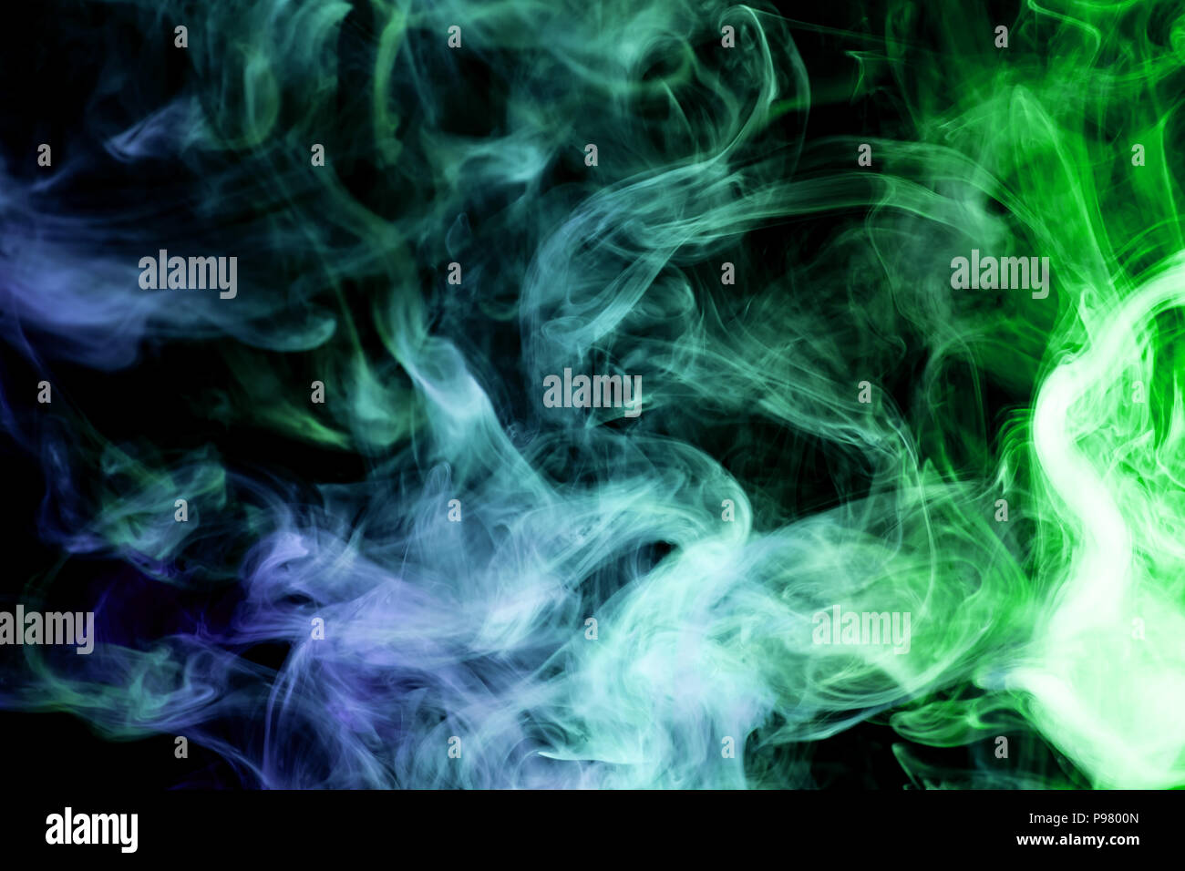 Blue and green smoke on a black isolated background. Background from ...