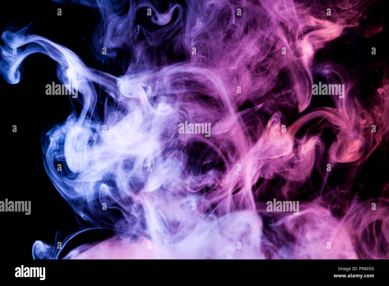 Blue and purple cloud smoke on black isolated background Stock Photo - Alamy