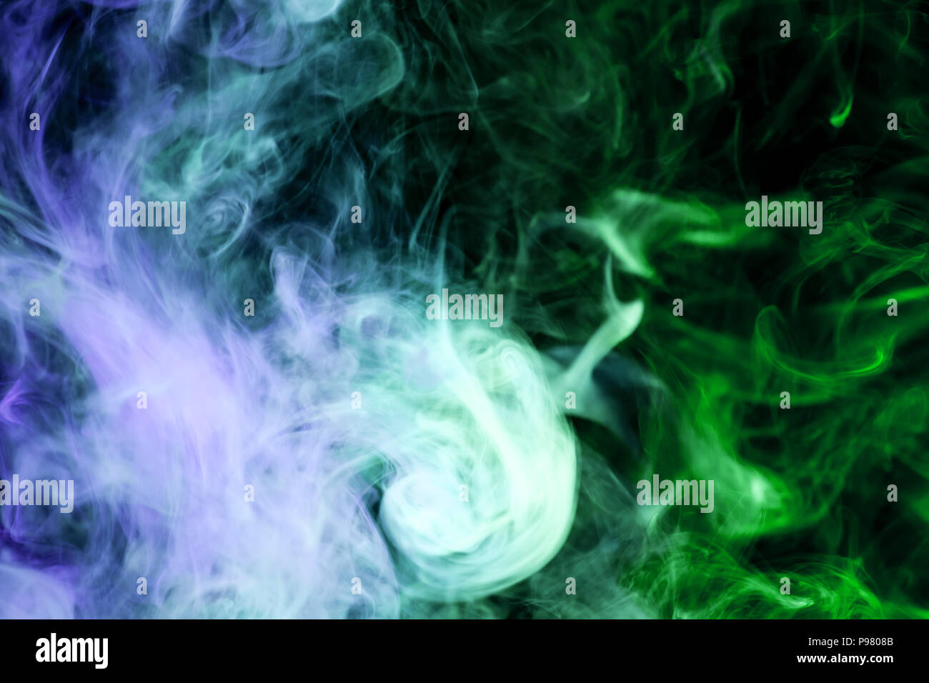 Blue and green cloud smoke on black isolated background Stock Photo - Alamy