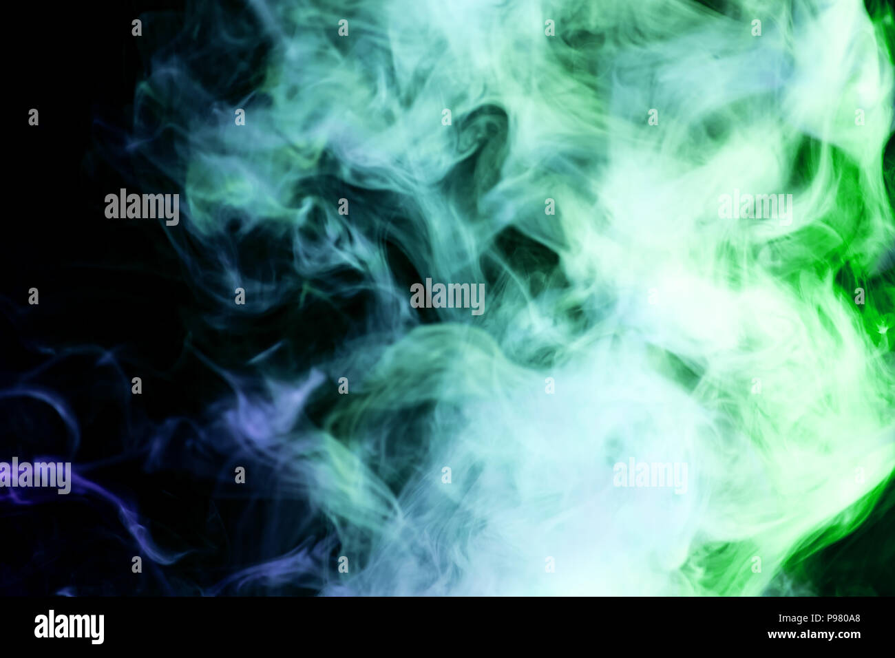 Blue and green cloud smoke on black isolated background Stock Photo - Alamy