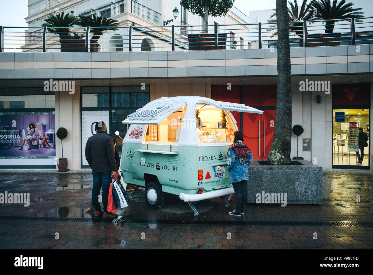 Lisbon, April 23, 2018: People buy frozen yogurt or ice cream from a street  vendor next to fashion outlet called Freeport. Street food and mobile comm  Stock Photo - Alamy