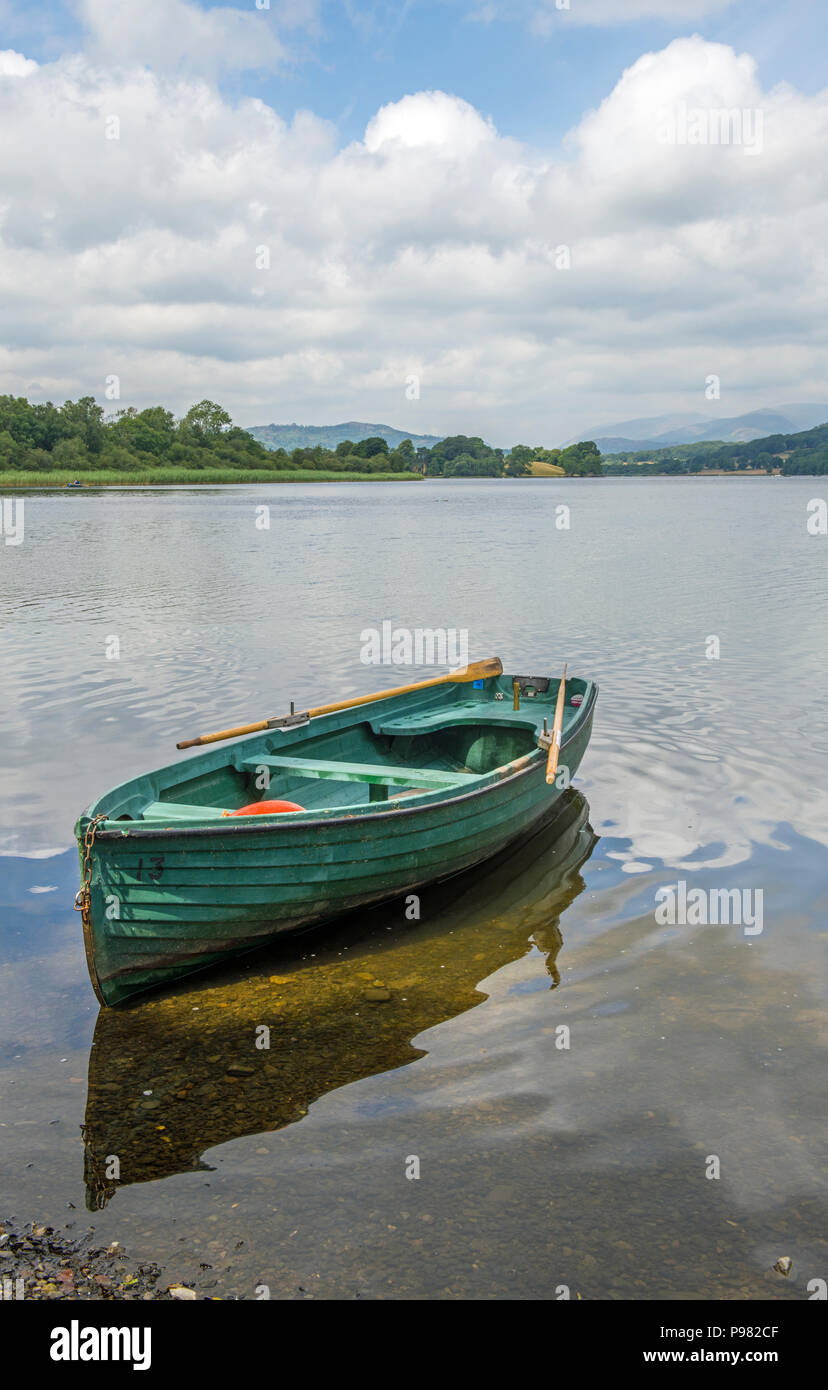 Esthwaite Water in the Lake District National Park with a green boat moored up. Stock Photo