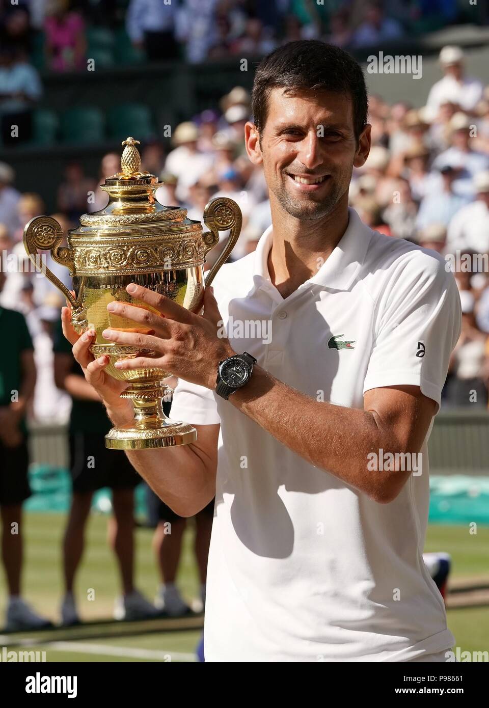 london-britain-15th-july-2018-novak-djokovic-of-serbia-shows-his-trophy-after-winning-the-mens-singles-final-match-against-kevin-anderson-of-south-africa-at-the-wimbledon-championships-2018-in-london-britain-on-july-15-2018-novak-djokovic-won-3-0-credit-guo-qiudaxinhuaalamy-live-news-P98661.jpg