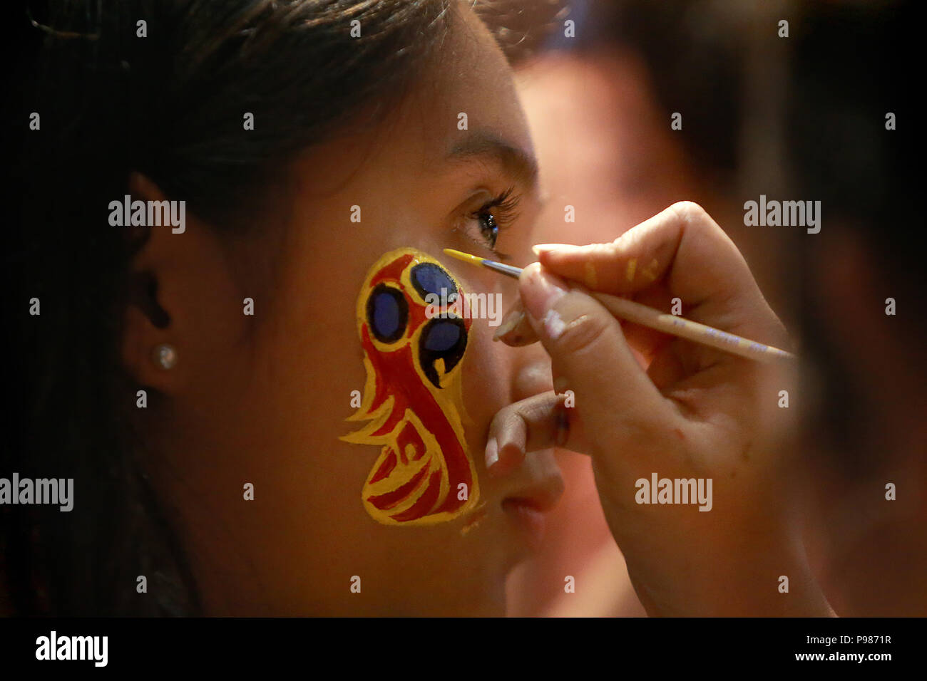 Pasig City, Philippines. 15th July, 2018. A fan has her face painted with the 2018 World Cup logo during a live viewing party of the 2018 FIFA World Cup final between France and Croatia at a bar in Pasig City, the Philippines, July 15, 2018. Credit: Rouelle Umali/Xinhua/Alamy Live News Stock Photo