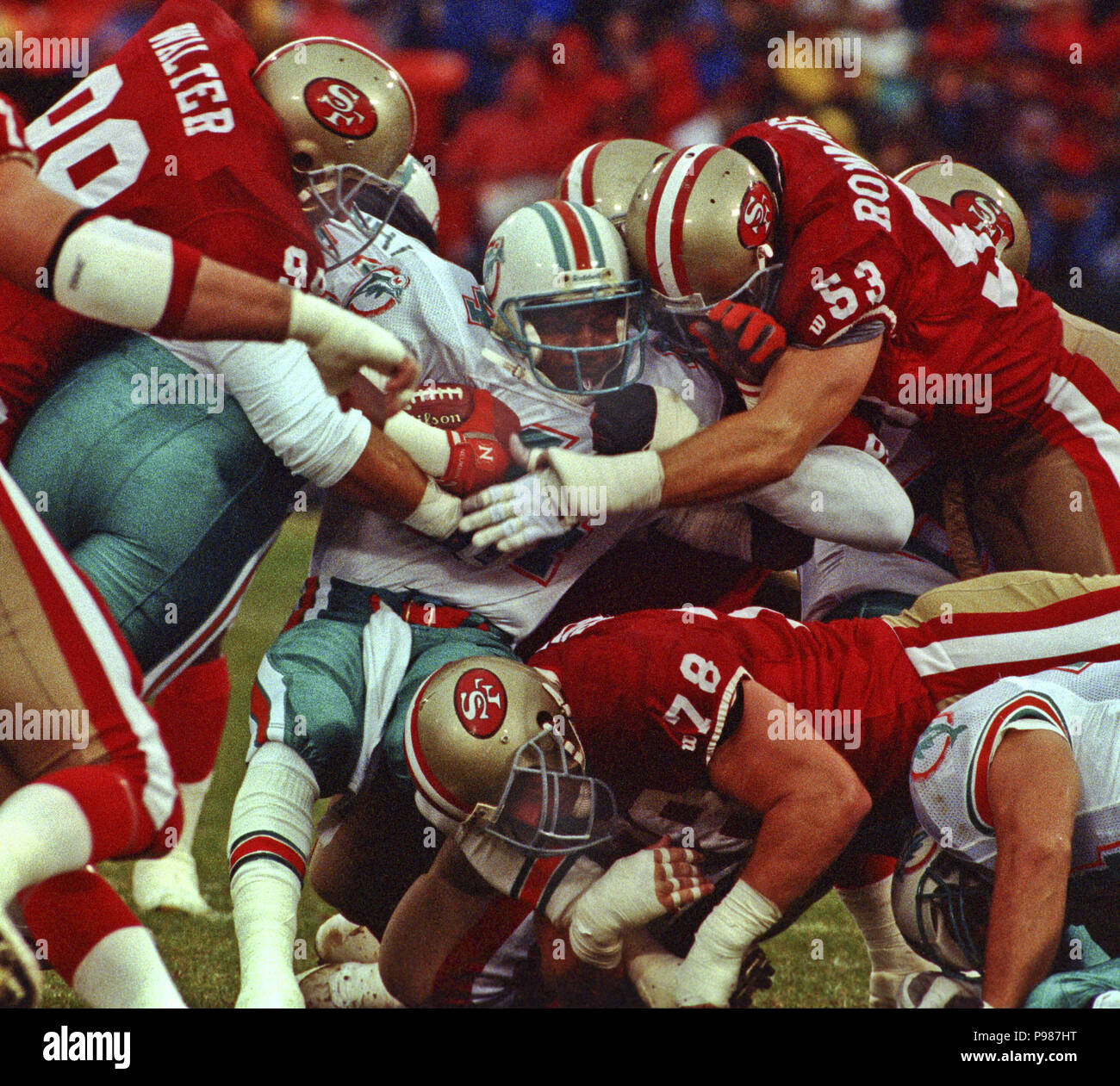 San Francisco, California, USA. 6th Dec, 1992. San Francisco 49ers vs.  Miami Dolphins at Candlestick Park Sunday, December 6, 1992. 49ers Beat  Dolphins 27-3. 49ers defender gang up on Dolphins running back