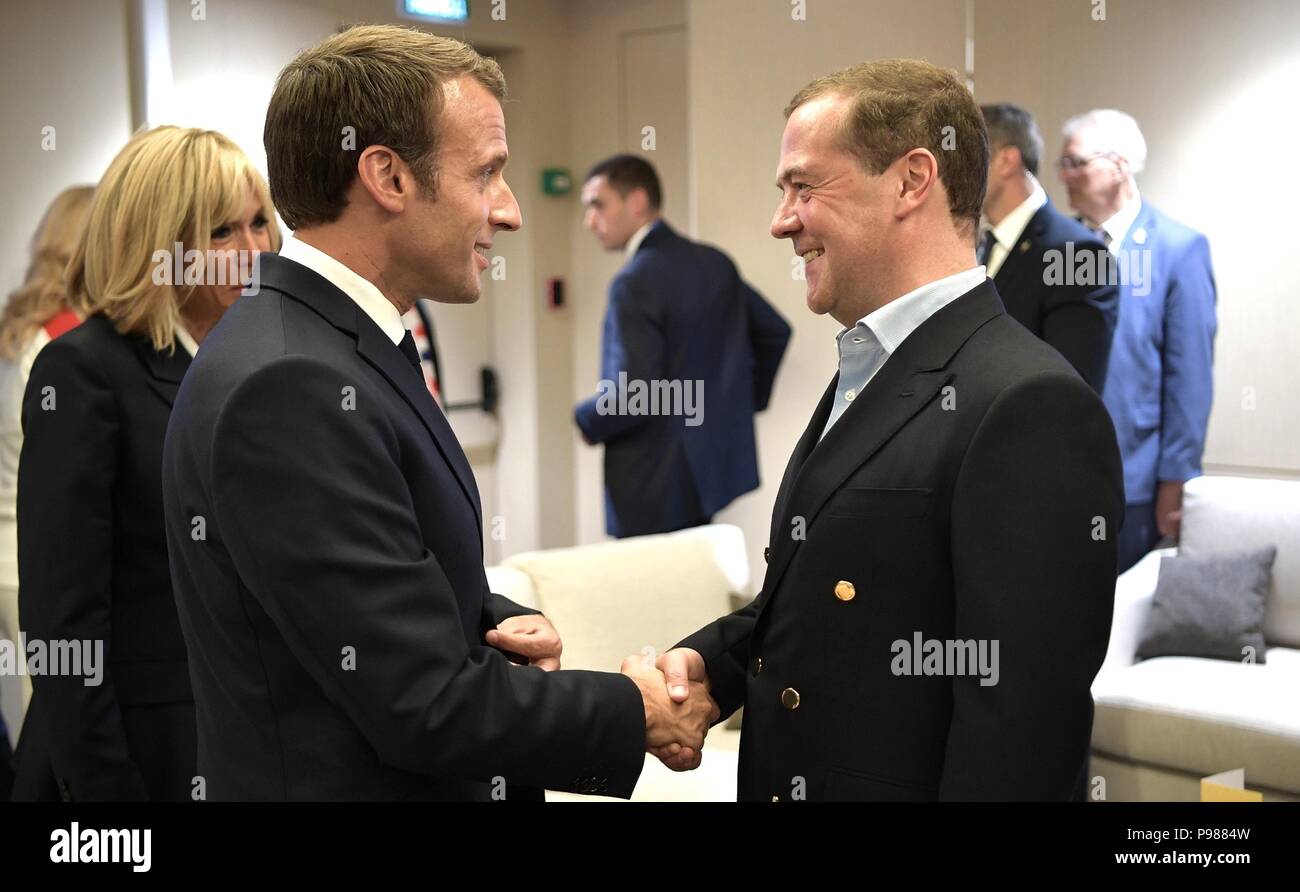 French President Emmanuel Macron, left, is congratulated by Russian Prime Minister Dmitry Medvedev during the 2018 FIFA World Cup Final at Luzhniki stadium July 15, 2018 in Moscow, Russia. France defeated Croatia 4-2. Stock Photo