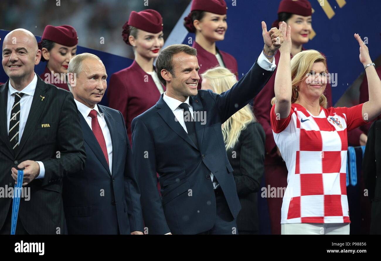 French President Emmanuel Macron, center, celebrates during the awards ceremony following the France victory in the 2018 FIFA World Cup Final at Luzhniki stadium July 15, 2018 in Moscow, Russia. Stand with Macron from left to right are: FIFA President Gianni Infantino, Russian President Vladimir Putin, French President Emmanuel Macron and Croatian President Kolinda Grabar-Kitarovic. Stock Photo