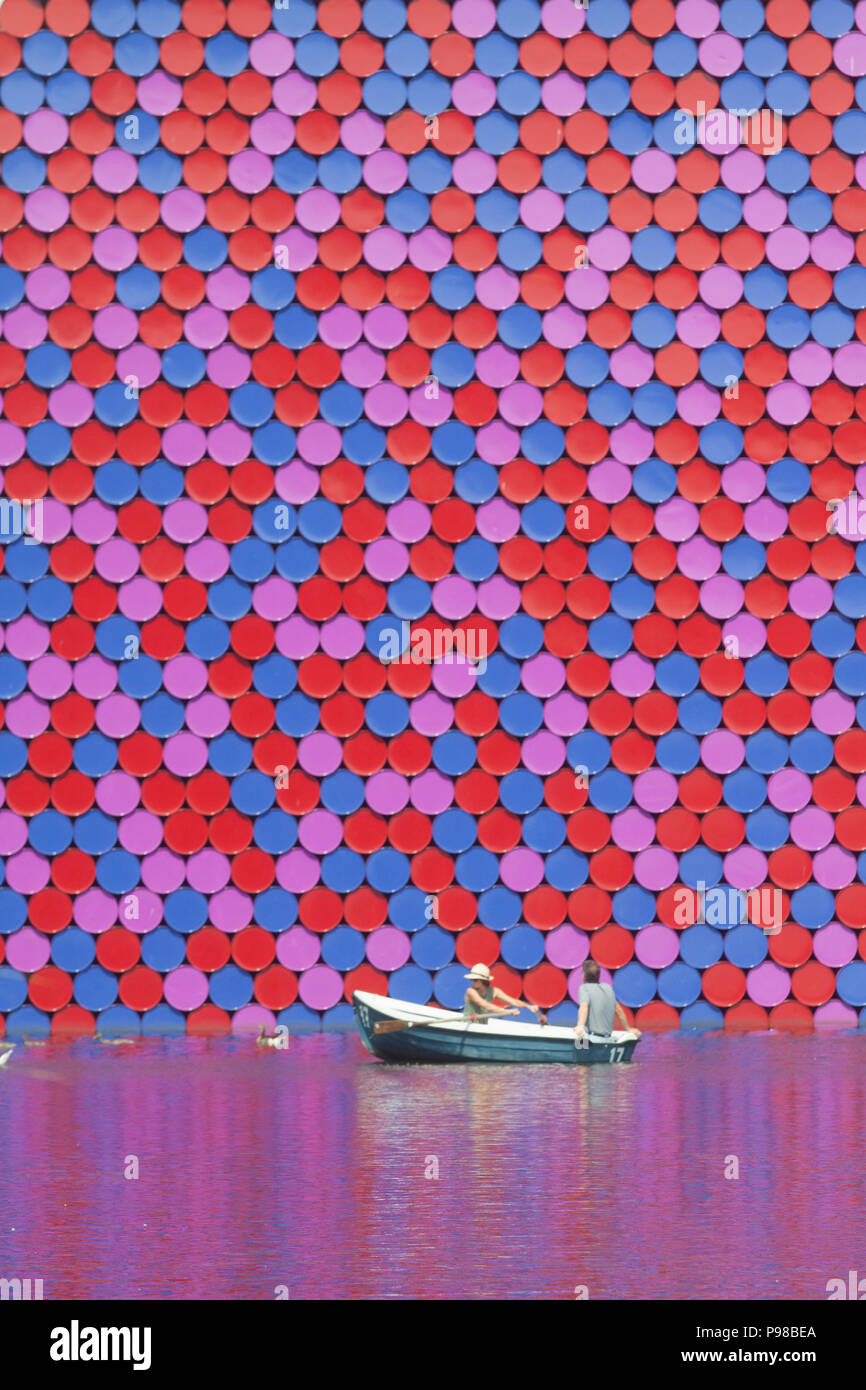 London UK. 16th July 2018. UK Weather: People enjoy paddling on pedalos on the Serpentine in  Hyde Park under blues skies and sunshine  with the backdrop of pyramidal Mastaba sculpture by Christo made of 7000 barrels on another hot day as the ongoing heatwave which has lasted more than 30 days is set to continue Credit: amer ghazzal/Alamy Live News Stock Photo