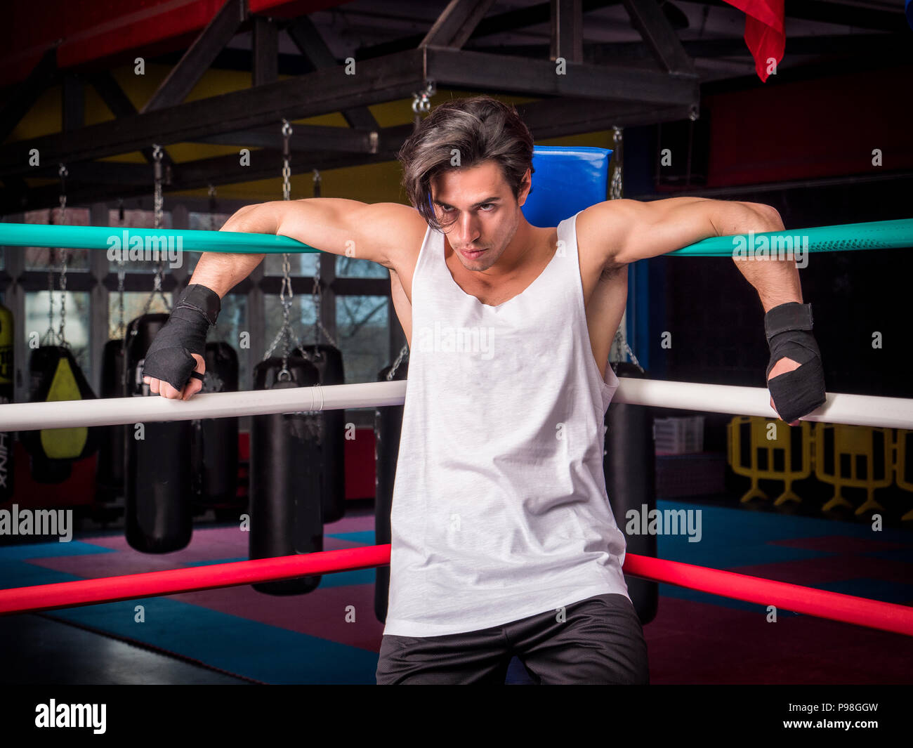 Determined muscular boxer hanging on ropes Stock Photo Alamy