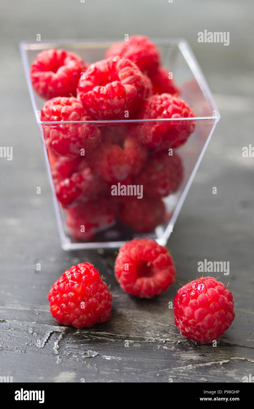 Cup full of fresh red raspberries on the table Stock Photo