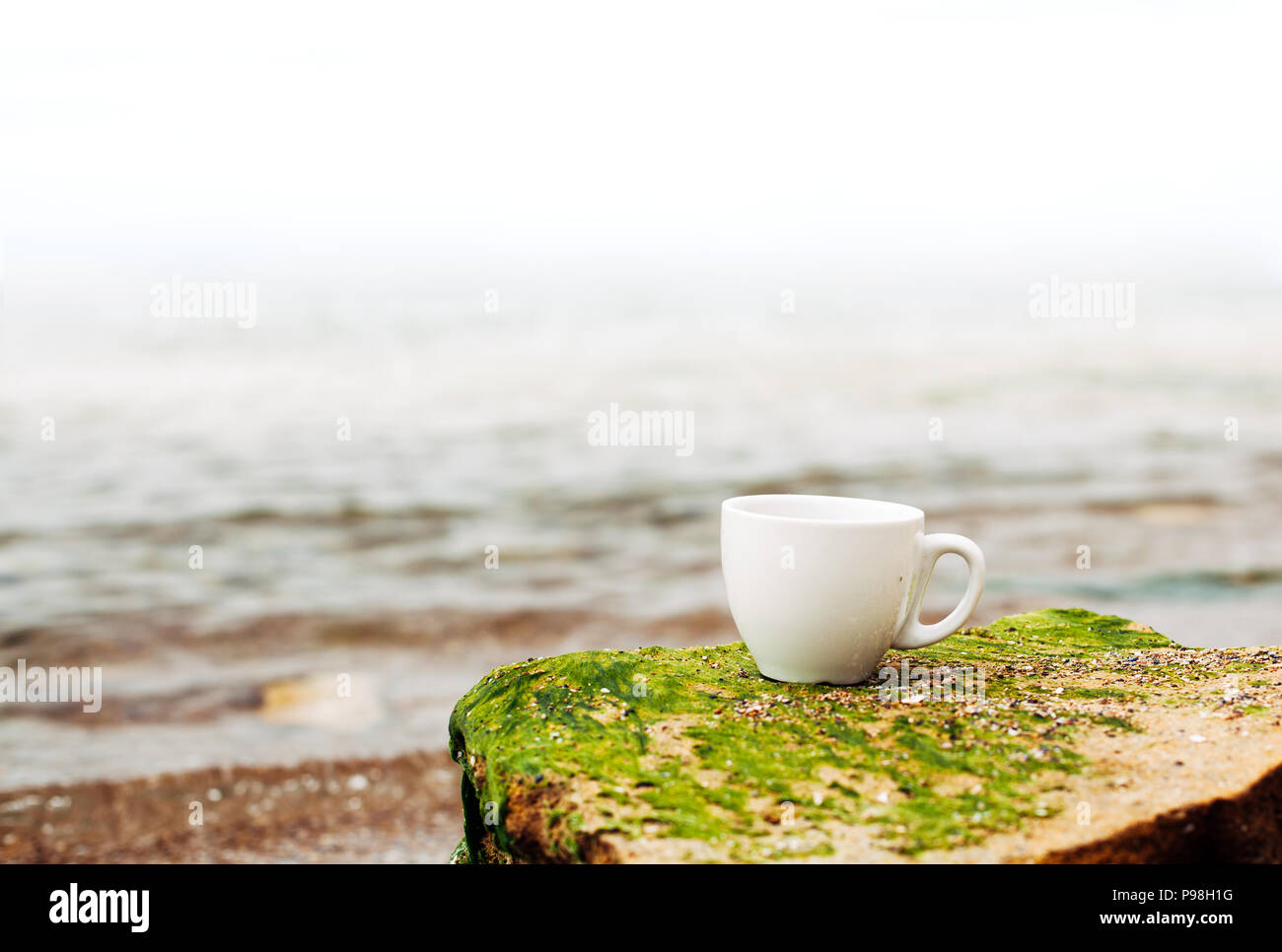 cup of coffee on the sea water and stone background. Sea freshness ...