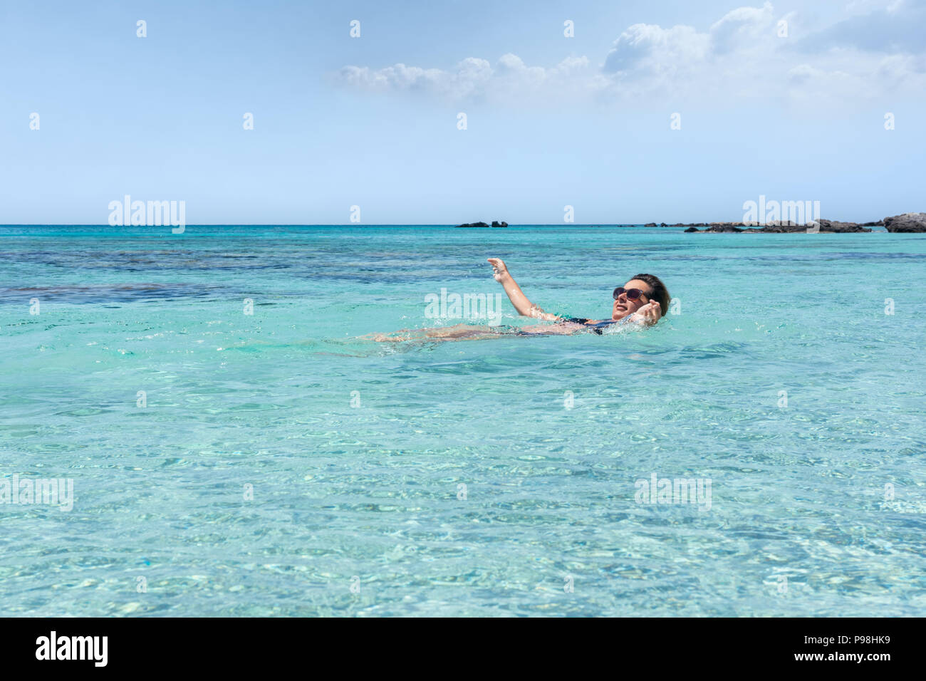 Woman swiming in the sea at Elafonisi beach, in the island of Crete Stock Photo