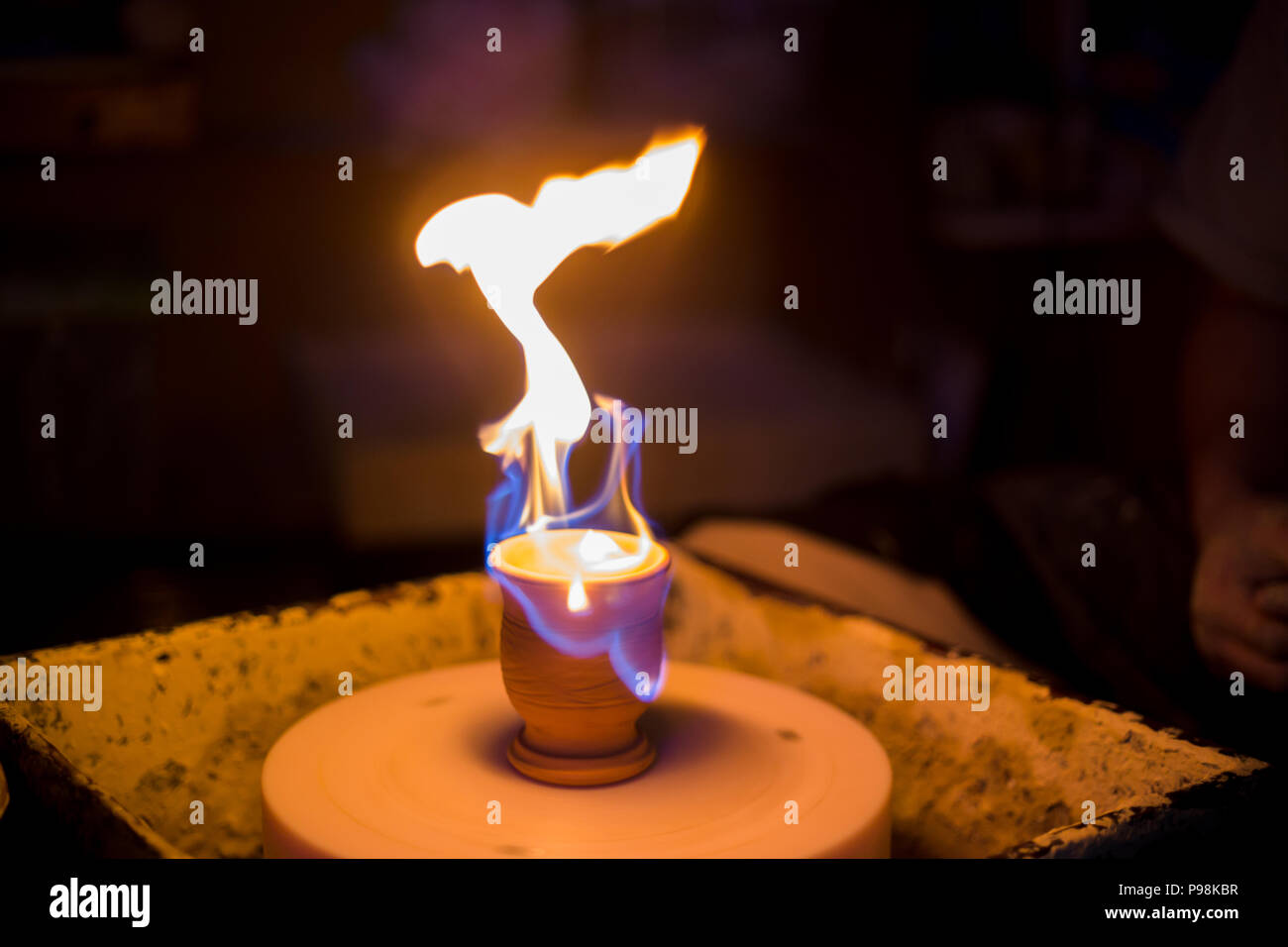 Burning ceramic mug on pottery wheel Stock Photo Alamy